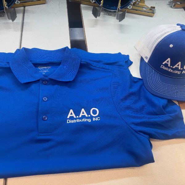 Royal blue polo with an embroidered company name and a matching trucker hat