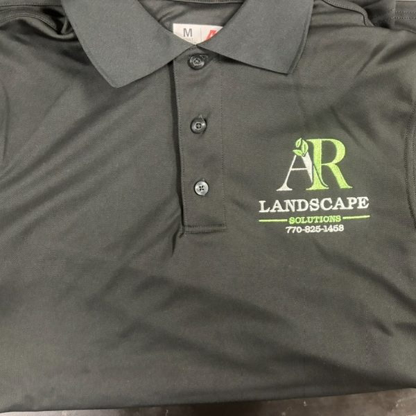 Dark gray dry fit polo with an embroidered landscape company logo