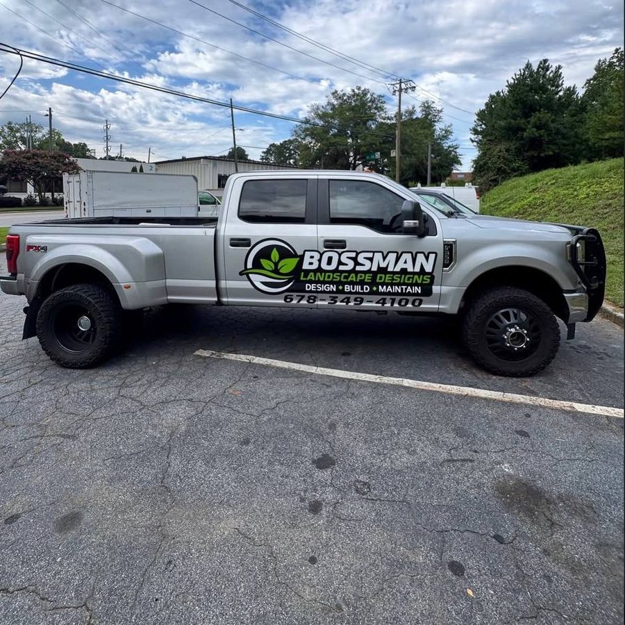 Silver pickup truck with landscape company door graphics
