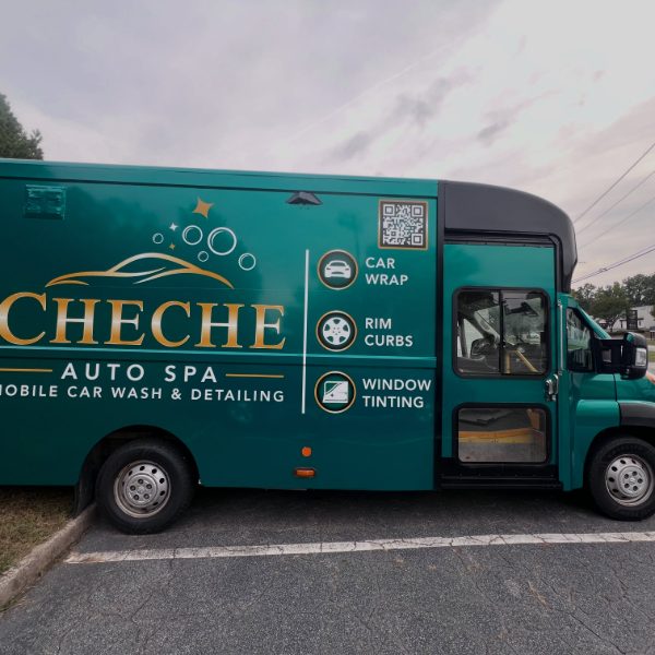 Teal mobile car wash van with gold logo and service graphics
