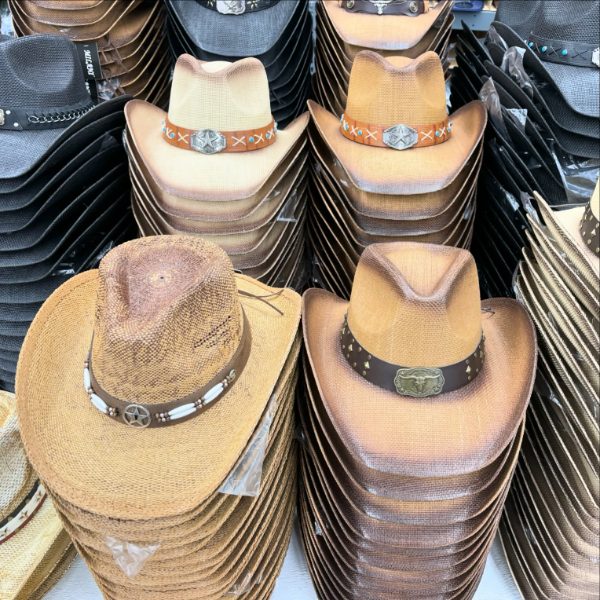 Stacks of straw cowboy hats with decorated bands