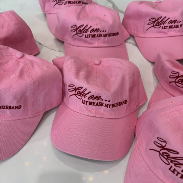 Pink dad hats with burgundy stitching