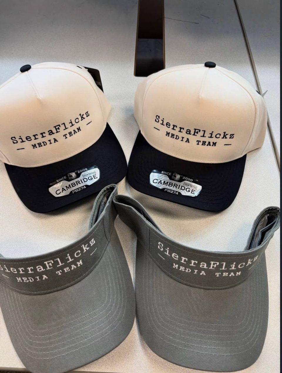 Hats and visors from a package deal for a media team