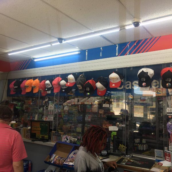 A row of hats on display behind a store counter