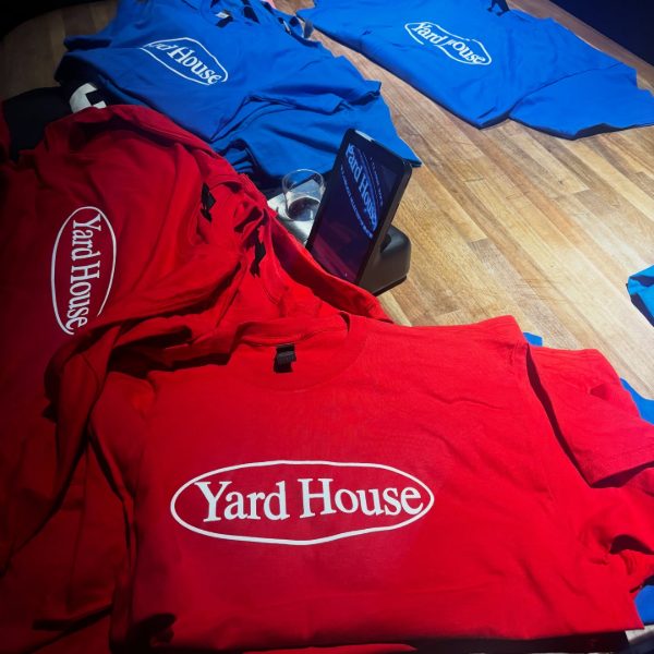Red and blue restaurant T-shirts with a white printed logo